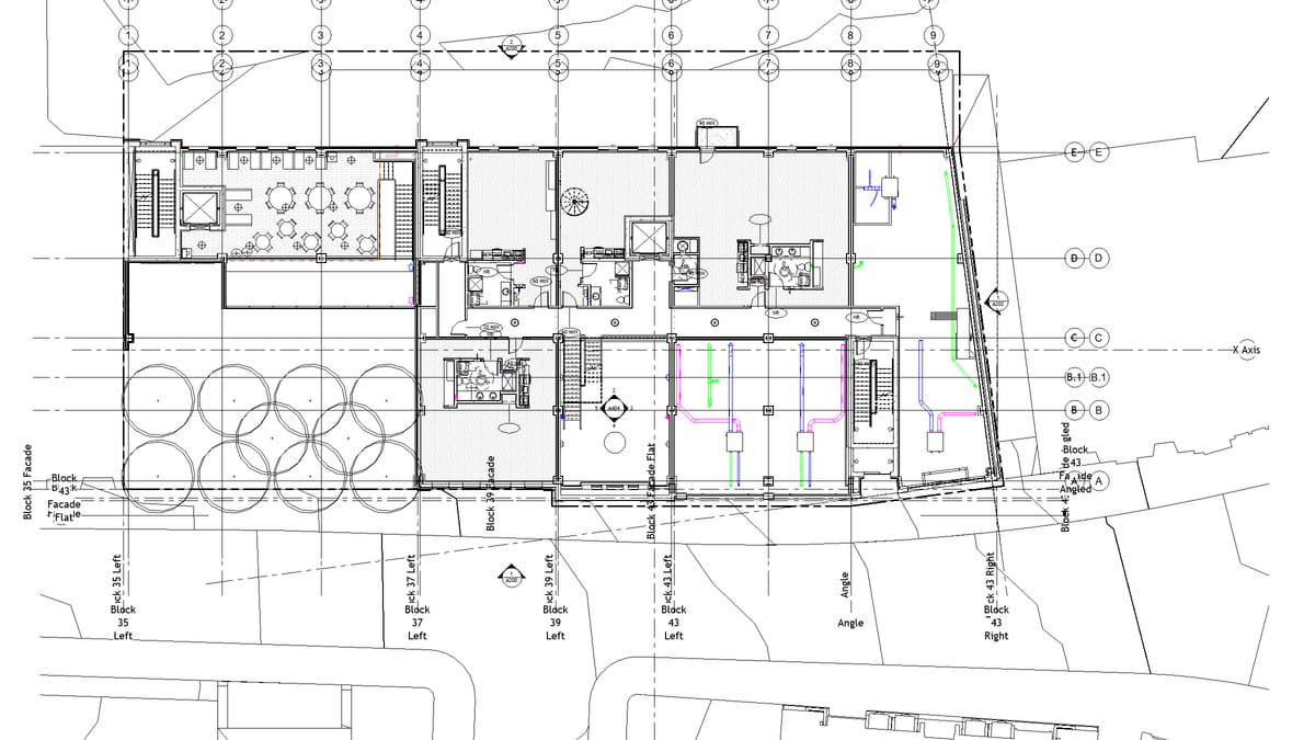 A Revit floor plan after a tagging pass, each new tag drawn with a leader to its door